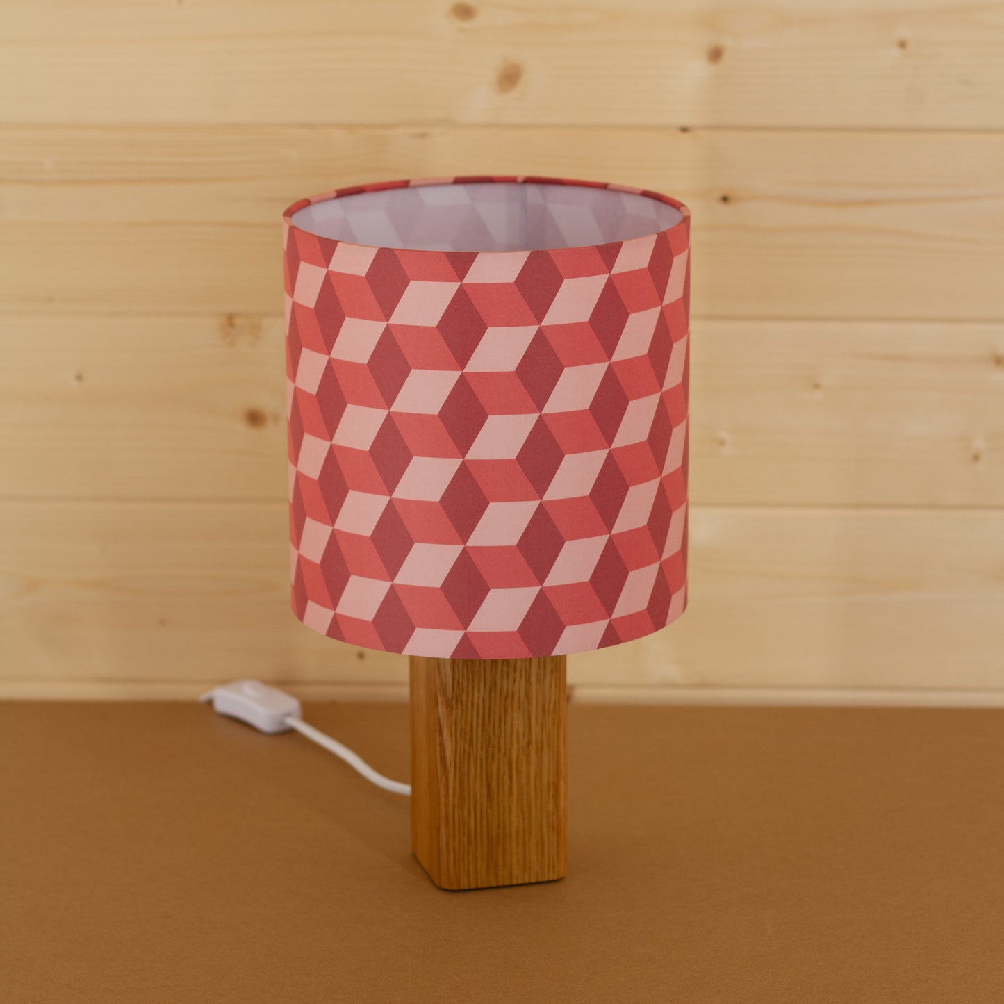 Red Cubes Geometric Print Lampshade on a Hardwood Table Lamp