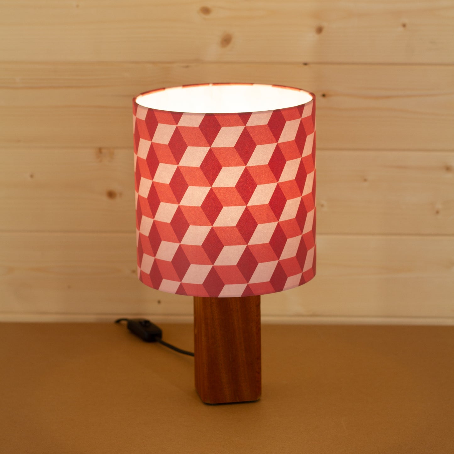 Red Cubes Geometric Print Lampshade on a Hardwood Table Lamp