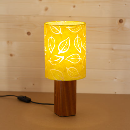 Lit Batik Leaf Yellow on Square Sapele Table Lamp Base, Handmade by Imbue Lighting on the Isle of Anglesey, Wales.