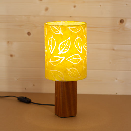 Lit Batik Leaf Yellow on Square Sapele Table Lamp Base, Handmade by Imbue Lighting on the Isle of Anglesey, Wales.